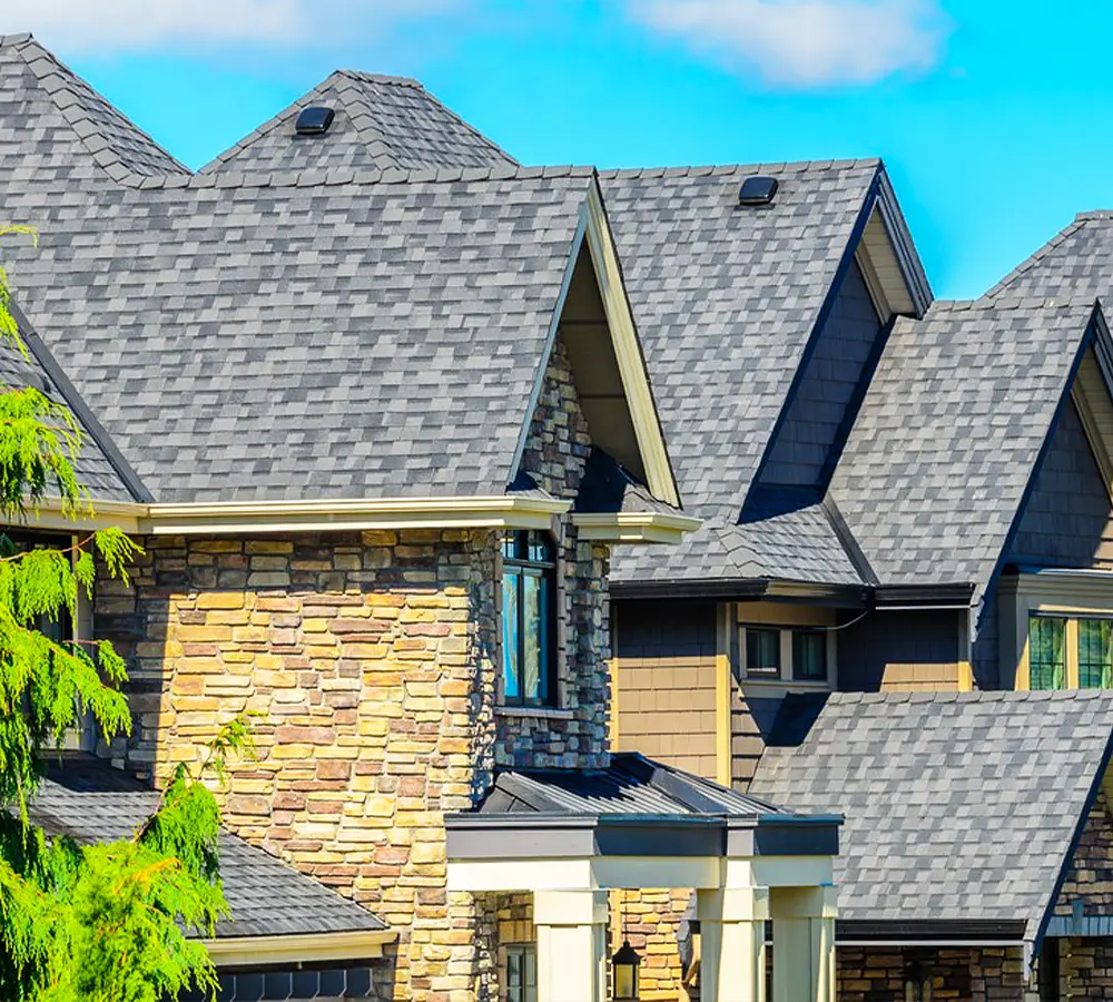 Close-up of a home with a newly repaired shingle roof, showcasing durable materials and expert craftsmanship.