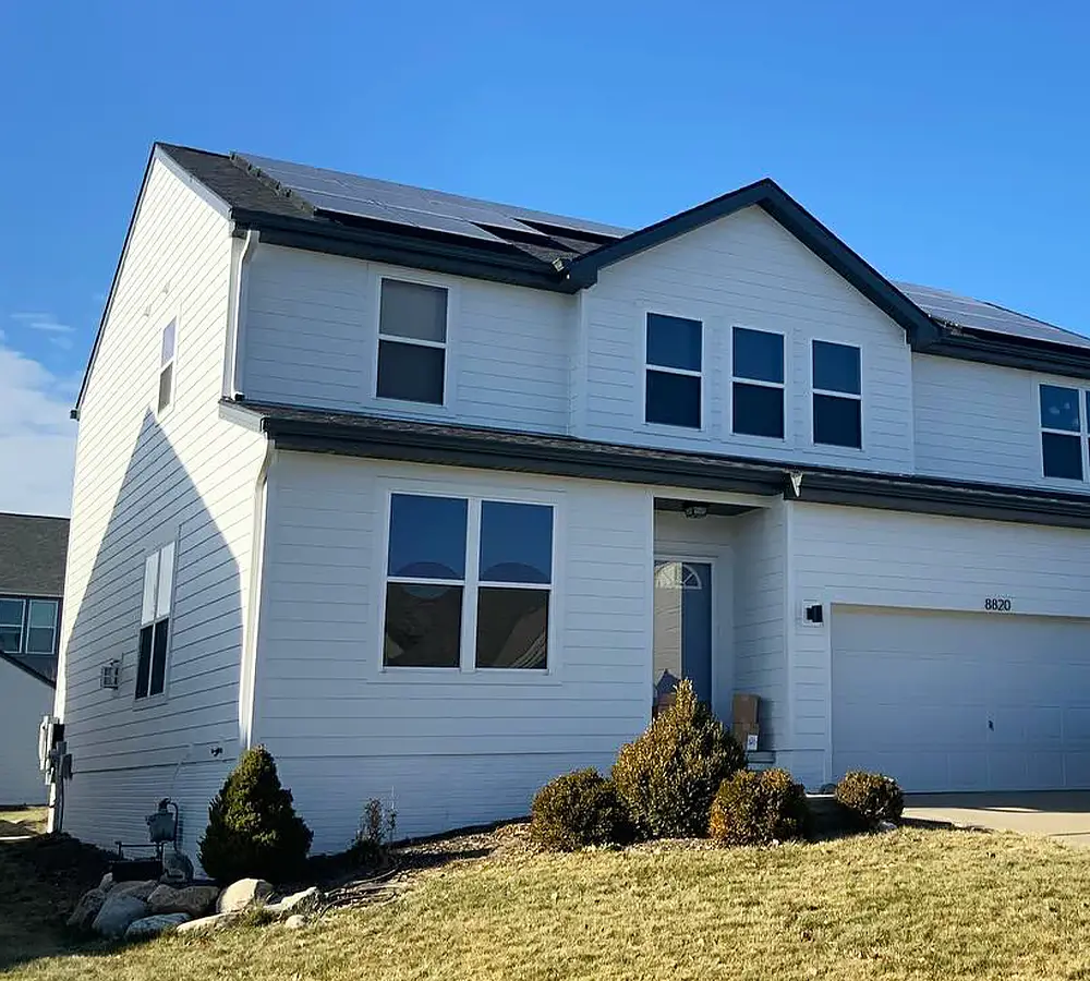 Modern white home with a repaired and refreshed siding, offering a clean and energy-efficient appearance.