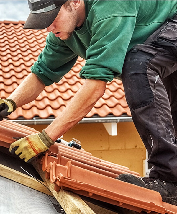 Roofer at work, installing clay roof tiles, roofing in Omaha Nebraska